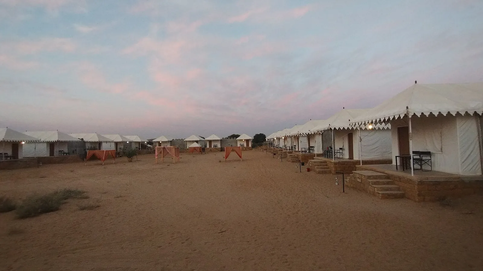 Row of Swiss tents at a Jaisalmer desert camp at dusk near the Sam sand dunes.