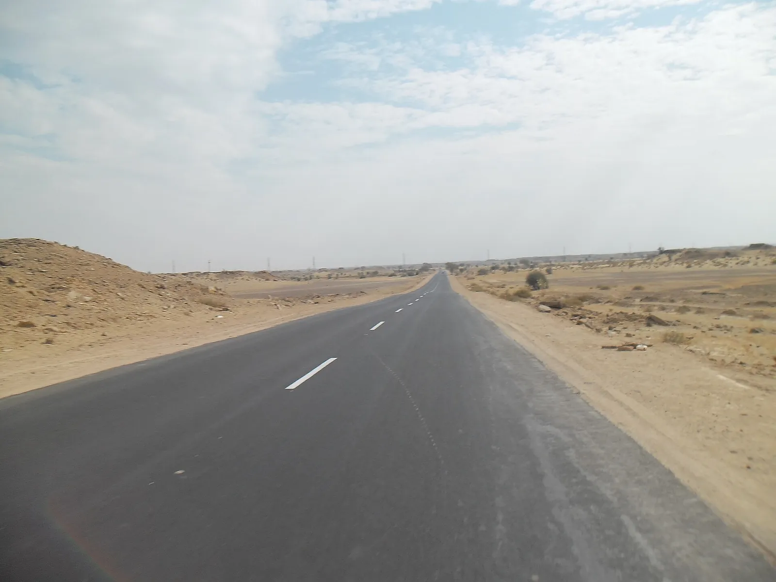 Open highway through the Thar Desert on the Jodhpur to Jaisalmer road trip by taxi.
